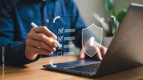 Cybersecurity checklist on laptop for online data protection and digital security compliance audit form