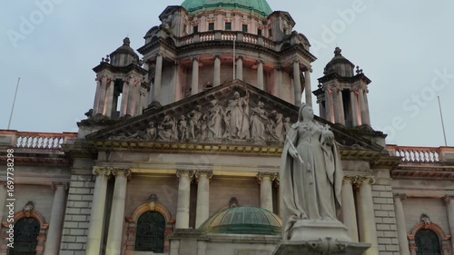 Aerial descent from the dome of Belfast City Hall down to the Queen Victoria statue at the entrance.