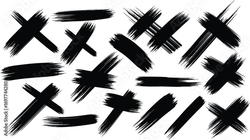 Collection of abstract black brush stroke marks and crosses on a white background