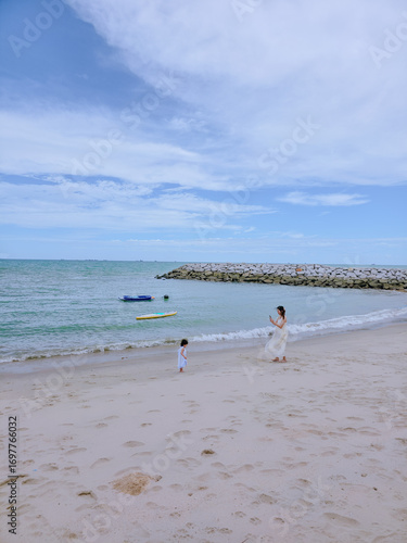 Kid on the beach. vacation of girl with mommy happy at the sea shore