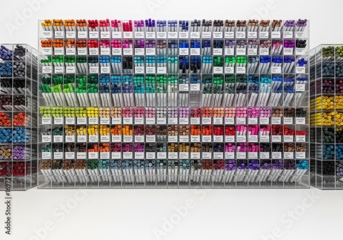 Colorful art markers neatly displayed in transparent racks