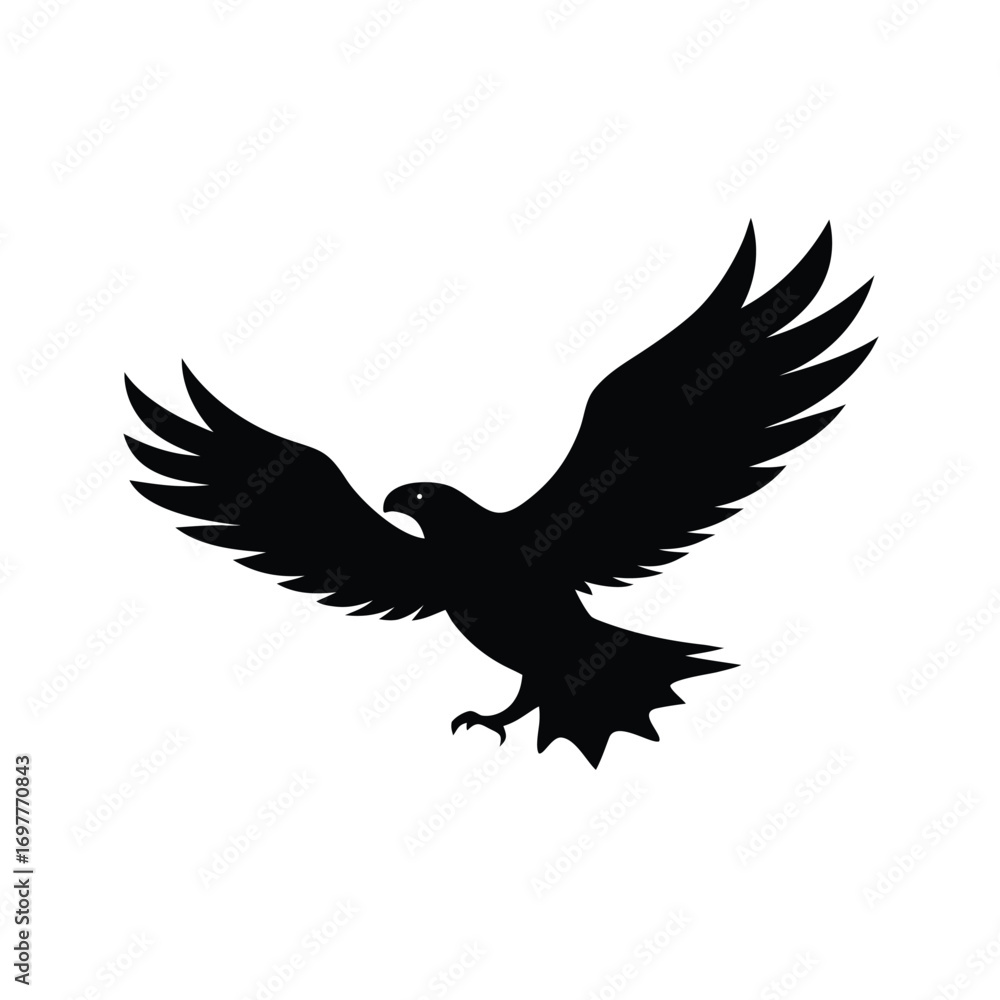 Fototapeta premium Majestic black silhouette of an eagle in full flight with wings spread wide