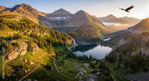 Majestic Alpine Mountain Landscape with a Serene Lake, Lush Green Forest, Flowing Waterfall, and an Eagle Soaring in the Sky