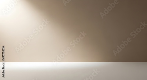 Beige wall with light shining on it, creating a simple and clean background.