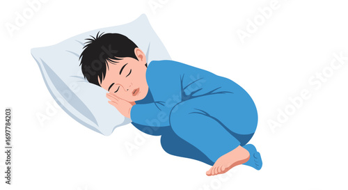 A young boy in blue pajamas sleeping soundly on a white pillow