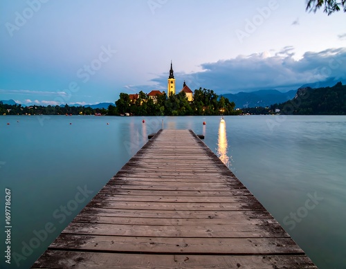 Lakeside church at twilight. Wooden pier leading to island