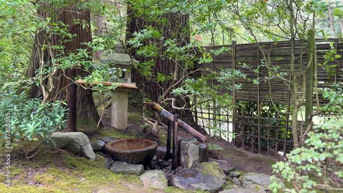 Tranquil garden scene with Shishi-Odoshi fountain and pagoda lantern at the Portland Japanese Garden