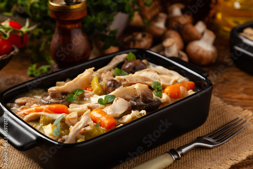 Obraz na płótnie Chicken casserole. Served in black pots.