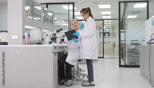 Wallpaper Mural Laboratory technicians review data during research process in modern facility Torontodigital.ca