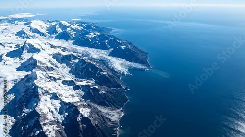 Wallpaper Mural Aerial View of Snow-Capped Mountains Bordering Calm Blue Ocean Torontodigital.ca