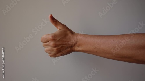 Woman hand showing thumb up sign with fingers white background, positive rating feedback, hand giving five stars review 