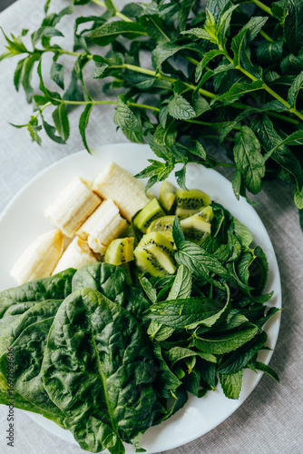 Fresh green smoothie ingredients: spinach, mint, kiwi and banana. Healthy food, recipes, health content	