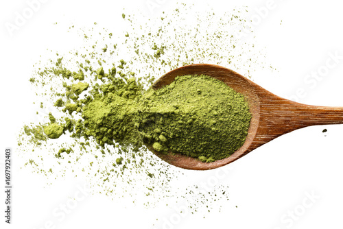 Wooden spoon holding a light green powder, with scattered powder around