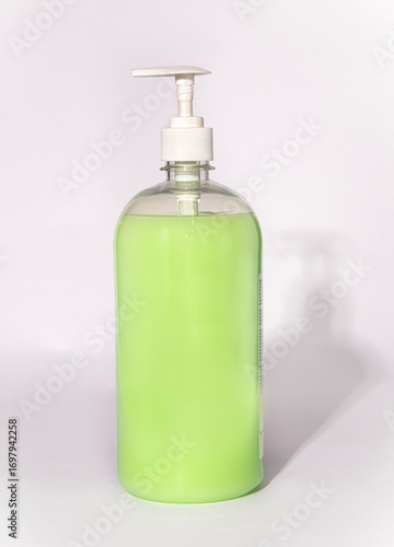 bottle of soap with dispenser on white background
