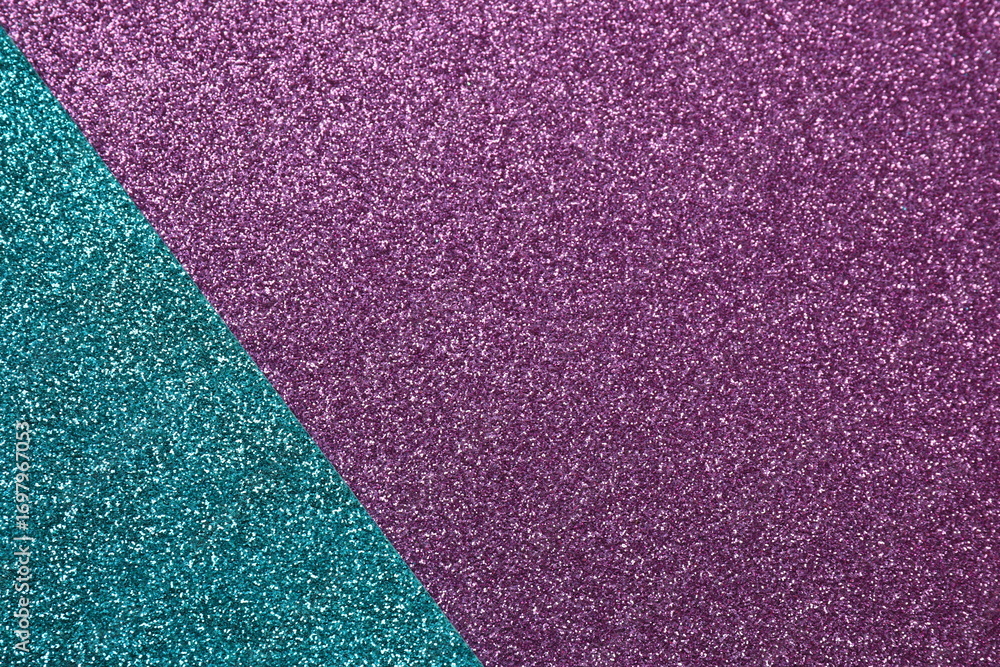 Fototapeta premium Abstract background filled with shiny purple and turquoisу glitter. Top view