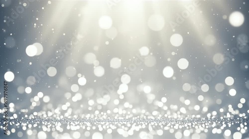 A blurred lightgray abstract image with many small and large white orbs and beams of light from the top