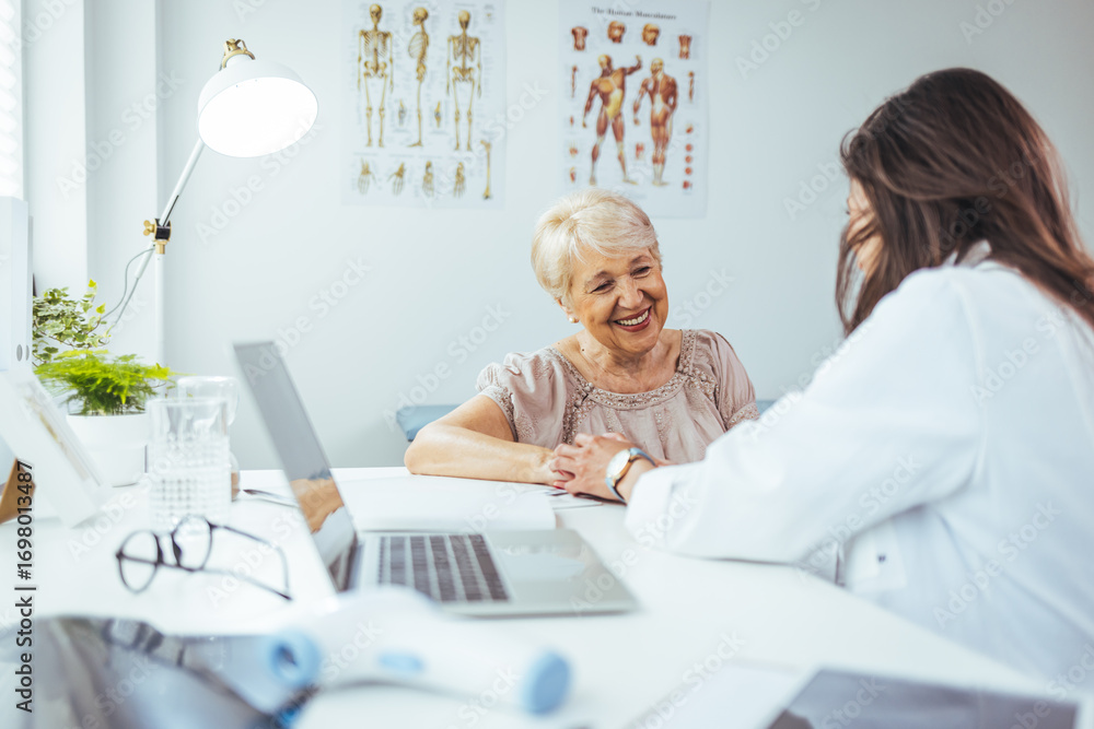 Fototapeta premium Doctor Consulting a Smiling Elderly Woman in a Bright Clinic Office