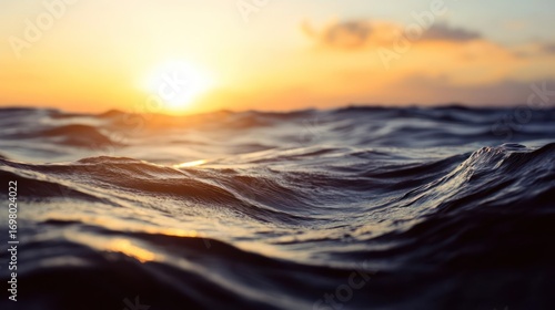 Mesmerizing sunset over undulating ocean waves reflecting warm golden light with a peaceful serene