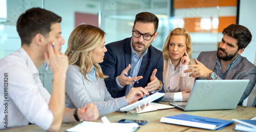 Business people fully engaged in discussion about company growth and future decisions