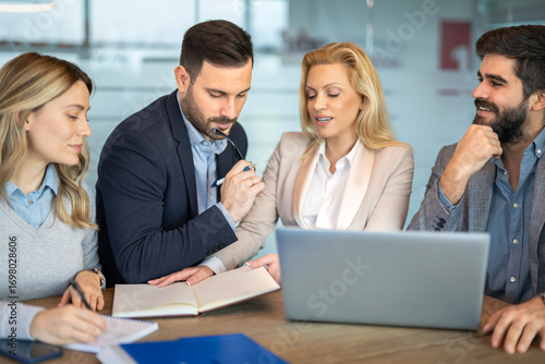 Business team focused on analyzing notes and data for strategic decisions