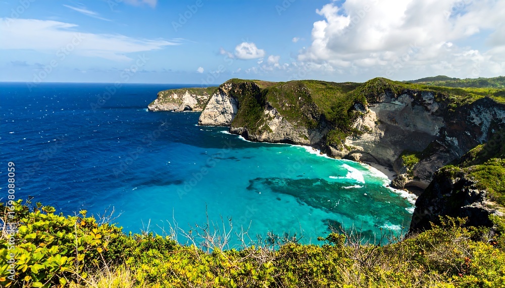 Fototapeta premium A scenic vista of a turquoise bay nestled within dramatic coastal cliffs under a vibrant blue sky.