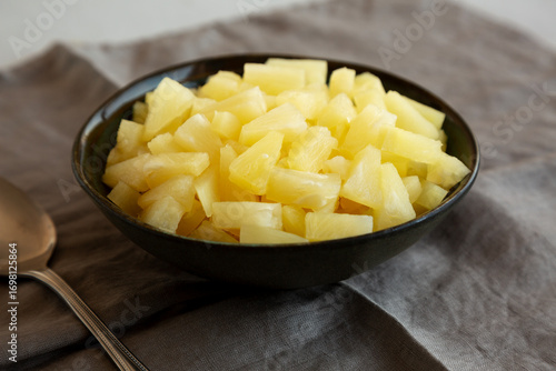 Canned Pineapple Tidbit Chunks in a Bowl, side view.