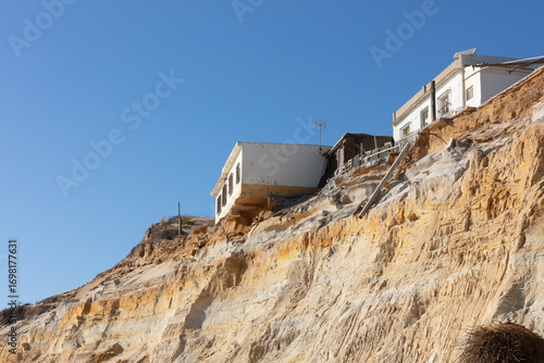 Fotografie Coastal erosion under houses in Almonte Donana National Park Andalusia Spain