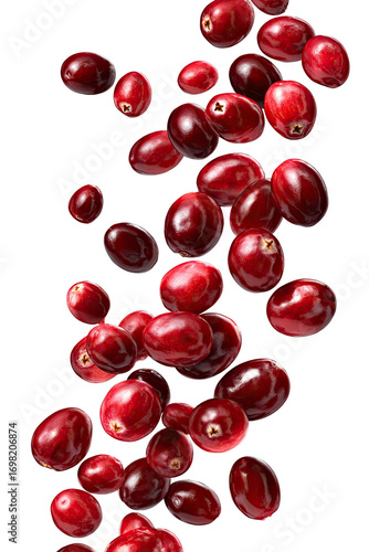 Vibrant red cranberries in mid-air, cascading downward against a dark background