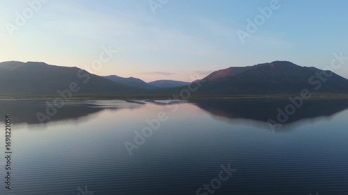 Wallpaper Mural Aerial view lingers over tranquil Lake Lama at evening glow, twin ridge reflecting on silky water. Motion emphasizes silence, long wave line and pure air of the remote Putorana Plateau in Siberia Torontodigital.ca