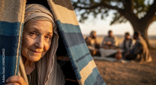 An elderly woman peeking from her tent, observing men gathered under a tree. Biblical concept of Abrahamic hospitality and desert life.