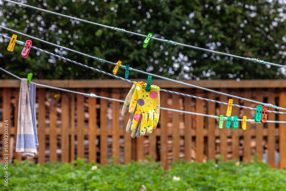 Hand is hanging on a clothesline with other clothes Hand is hanging on a clothesline with other clothes