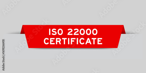 Red color inserted label with word ISO 22000 certificate on gray background