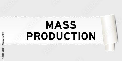 Ripped gray paper background that have word mass production under torn part