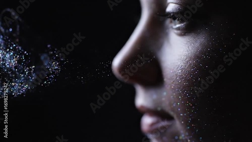 Glittering air: artistic slow motion capture of sparkling particles exhalation and portrait