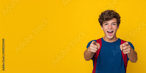 Excited teenager with backpack pointing to blank area, showing enthusiasm, great for education or online course promotions. student copy space, school marketing, pointing teen, lea