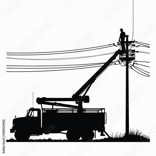 Silhouette of utility worker in bucket truck near power lines