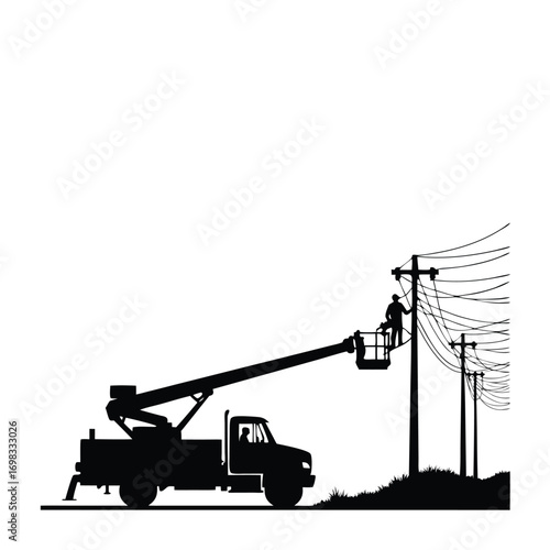 Silhouette of worker in aerial lift truck servicing electrical wires