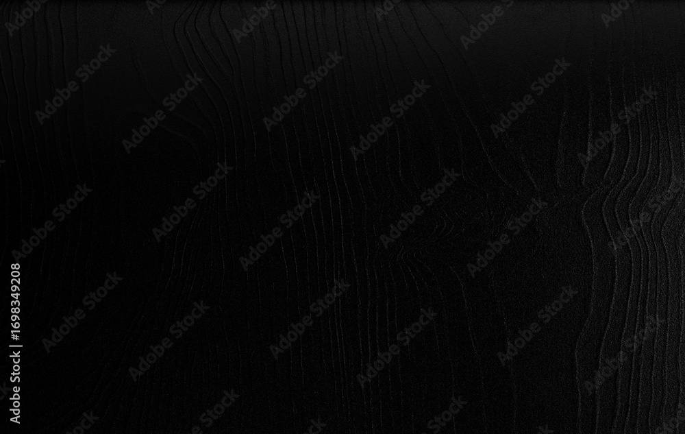 Naklejka premium Black silk fabric texture with smooth folds and shiny surface, elegant luxury background for design and decoration.