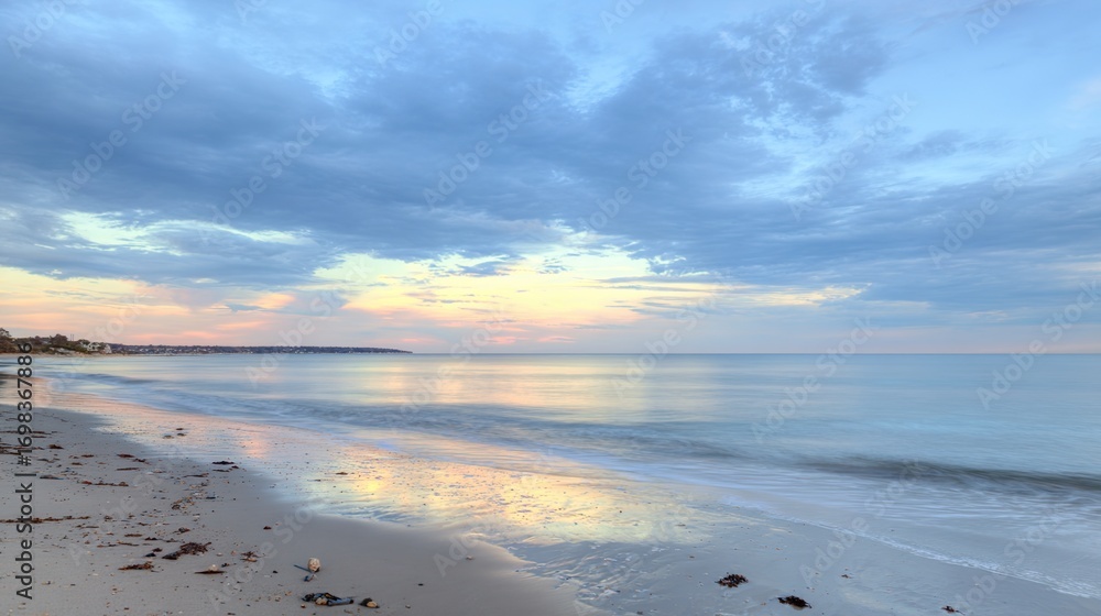 Obraz premium Soft Pastel Sunset Over a Calm Ocean Beach: Gentle Pink & Lavender Sunset Glow, Serene Beach with Calm Waves—Tranquil Coastal Scene of Pastel Hues at Dusk