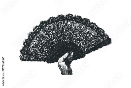 Hand holding a detailed black lace fan with ornate patterns
