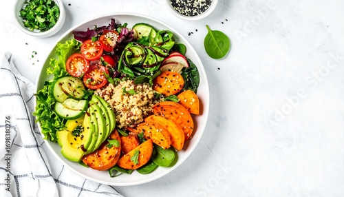 Colorful healthy bowl with quinoa, roasted sweet potato, avocado, and fresh vegetables