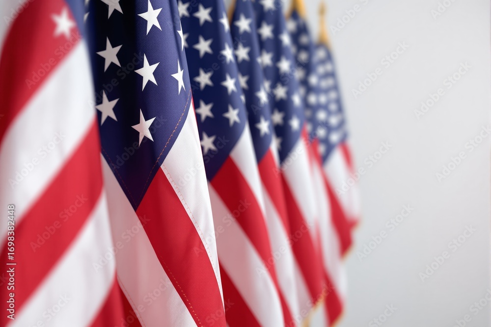Fototapeta premium Multiple American flags displayed in a row, close-up angle with shallow depth of field, soft neutral background, concept of patriotism and unity, Ai generative