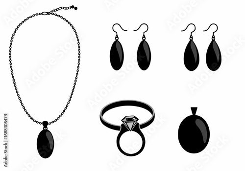Elegant black and silver jewelry collection featuring a necklace with an oval pendant, matching drop earrings, a diamond ring, and a separate pendant, all isolated on white.