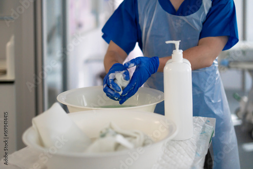 Tableau sur toile Nurse washing hands with soap and water in hospital setting
