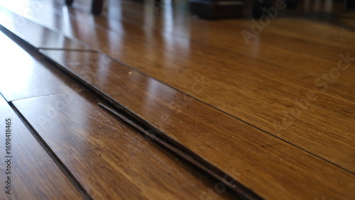 Canvas Print Corrugated wooden floor due to expansion at Living room.
