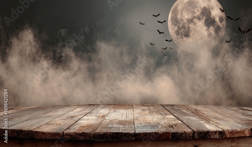 Rustic wooden table against a spooky night sky with full moon and bats for Halloween.