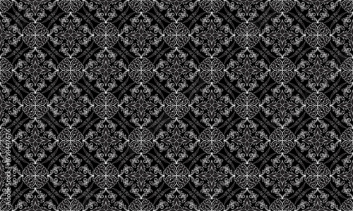 This seamless damask vector pattern in black  and white is perfect for use on fabrics such as upholstery, curtains, bedding, tablecloths, rugs,  and fashion textiles, adding luxury to any design.
