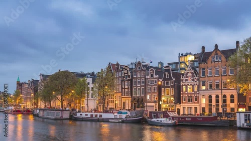 Amsterdam Netherlands time lapse day to night city skyline at canal waterfront