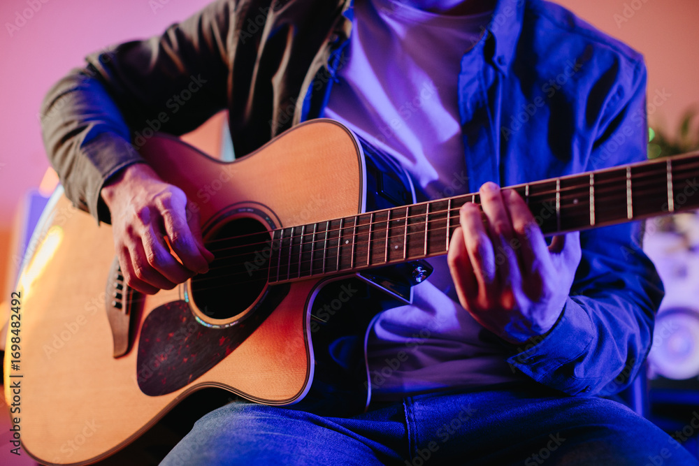 Obraz premium Musician composing music playing acoustic guitar at home