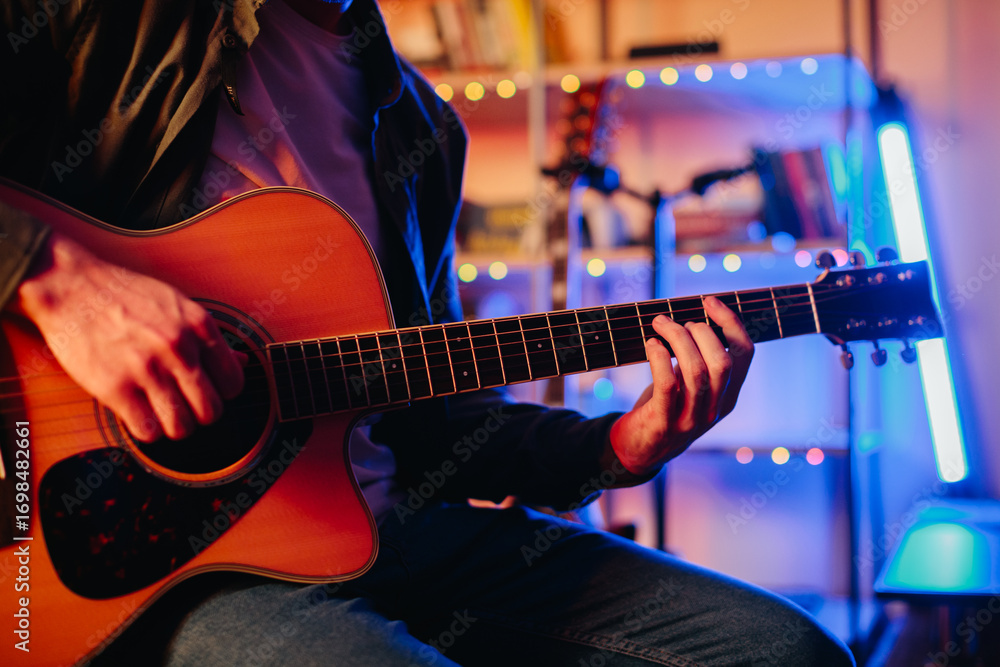 Obraz premium Musician composing music playing acoustic guitar at home